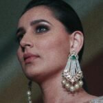 Portrait of a woman in traditional attire adorned with elegant jewelry, showcasing fashion and style.
