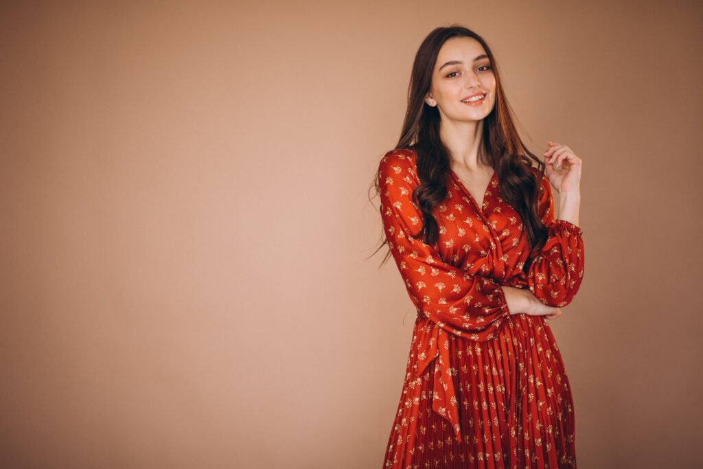 Young woman in a beautiful red dress in studio